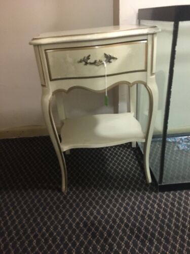 Louis XV bedside table with serpentine drawer front.