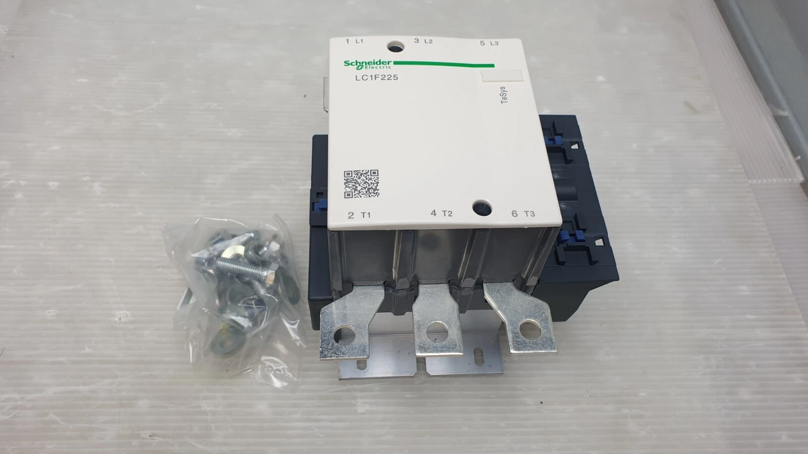 Schneider LC1F225 contactor front, terminals L1 L2 L3 and T1 T2 T3, with bag of bolts