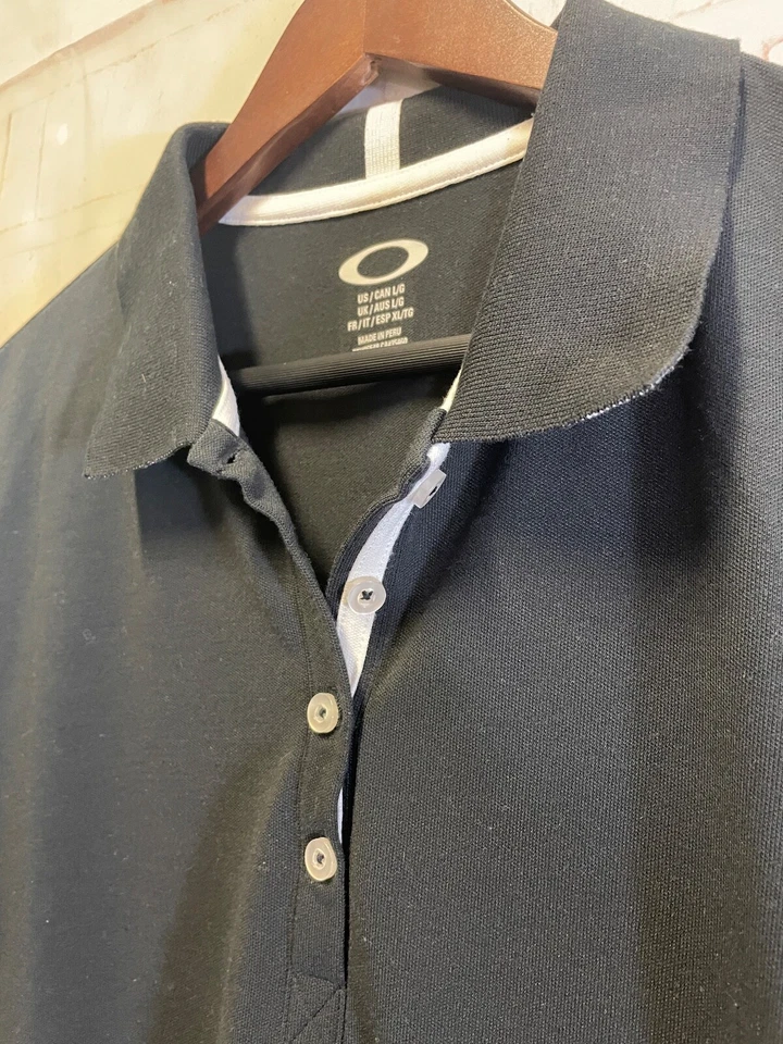 Blusa deportiva de golf Oakley blanca y negra con cuello para mujer mediana Foto 2 de 4