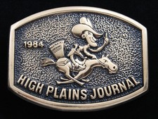 RE15104 VINTAGE 1984 HIGH PLAINS JOURNAL ADVERTISEMENT SOLID BRASS BUCKLE