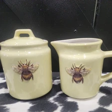 Bee Themed Creamer & Sugar From The Old Pottery Company.  Color Light Yellow.