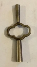 AN ANTIQUE / VINTAGE BRASS DOUBLE ENDED CARRIAGE CLOCK WINDING KEY