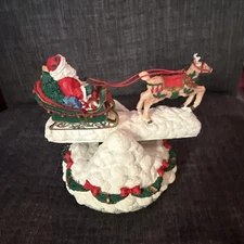 Musical See-Saw Santa Wind Up Plays “Santa Claus Is Coming To Town”