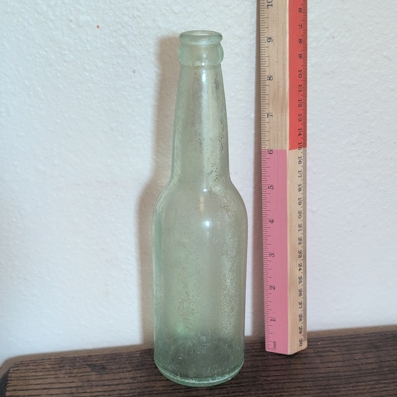 Clear Glass Bottle with Embossed “G6” Marking on Bottom/Base
