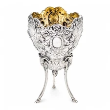 Hanau sterling silver tripod cup, repoussé putti, floral garlands and ram heads