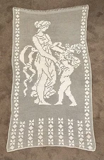 Hand-crocheted white cotton filet lace textile with figural and geometric motifs