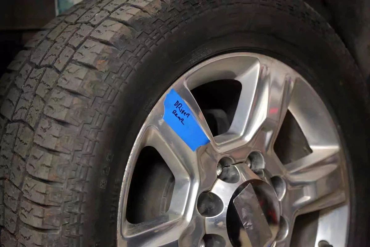 A pickup truck tire marked with a “driver rear” note to designate its original location on the vehicle.