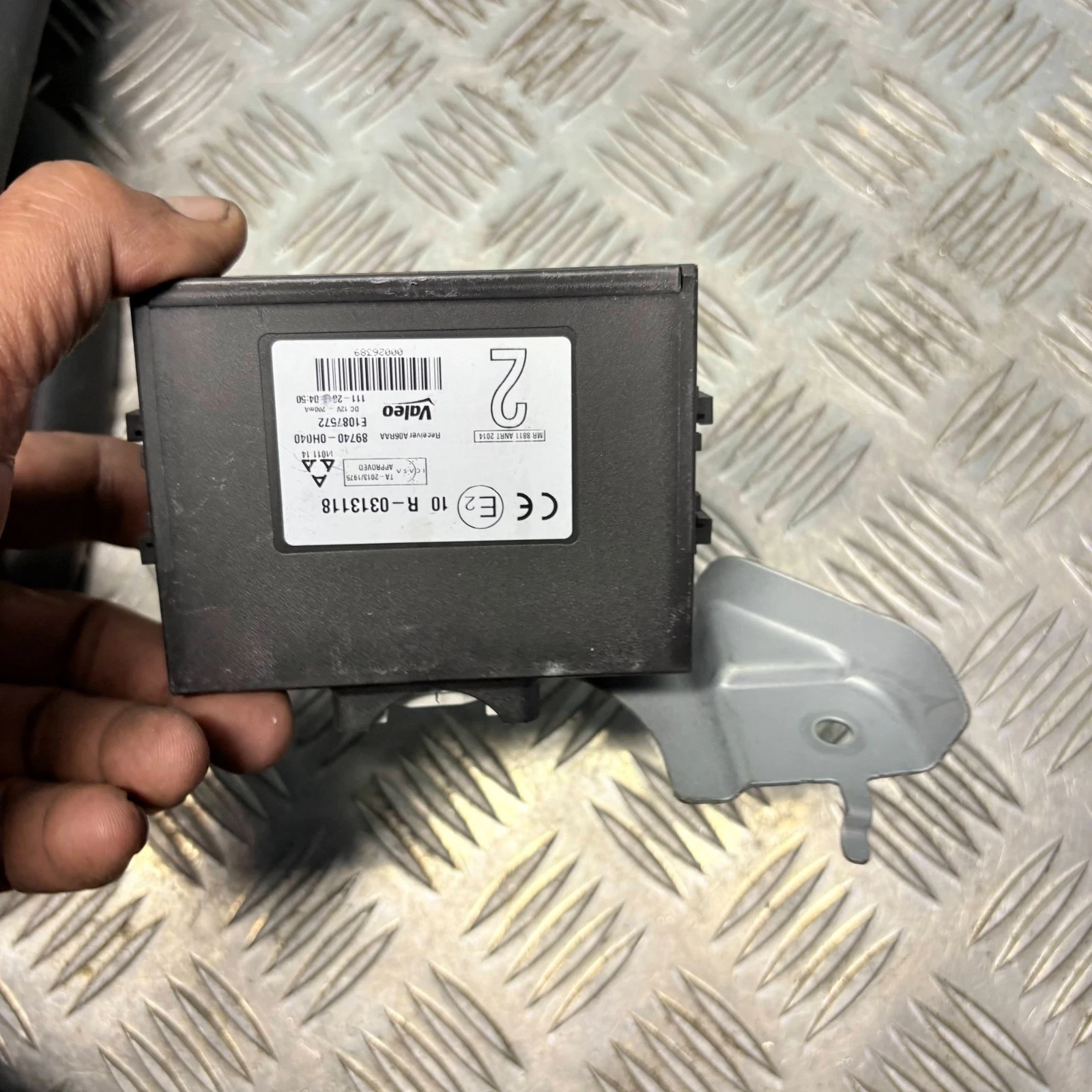 Door control receiver module with metal mounting bracket