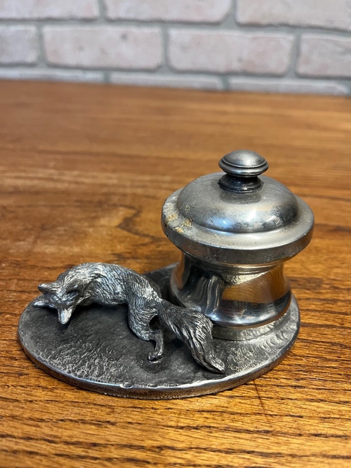A pewter fox-hunting inkwell that looks like it belongs on a Victorian gentleman's desk — atmospheric, sculptural, and deeply niche in the best way.