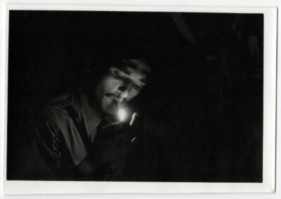 photo snapshot c.1970 lighting the fire - cigarette - light dark