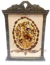 Vintage pressed dried flower art piece in an ornate metal frame