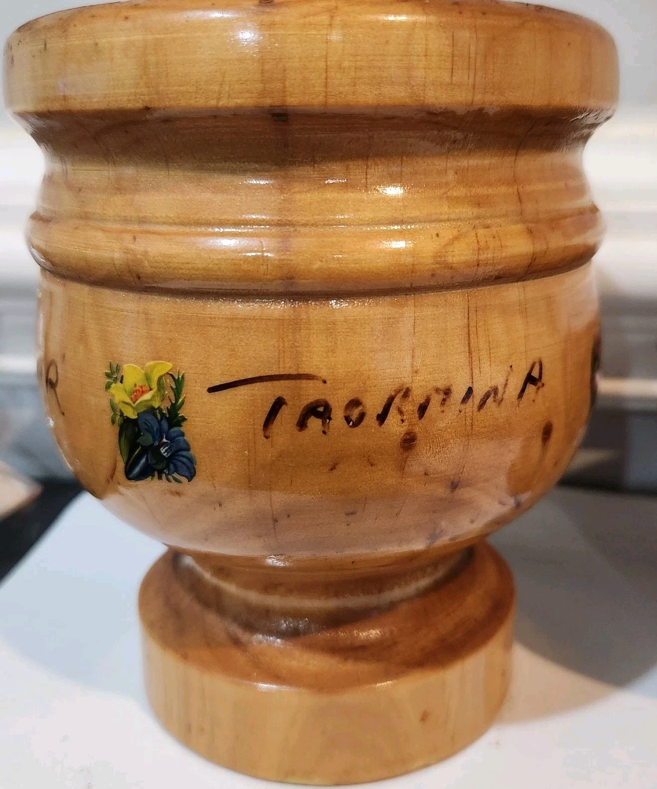 Vintage wooden mortar, part of a mortar and pestle set, with "TAORMINA" written