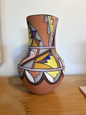 Vintage hand-painted Jemez pottery vase with geometric designs.