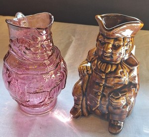 2 Toby Pitchers: Brown Glaze and Cranberry Glass With Handles