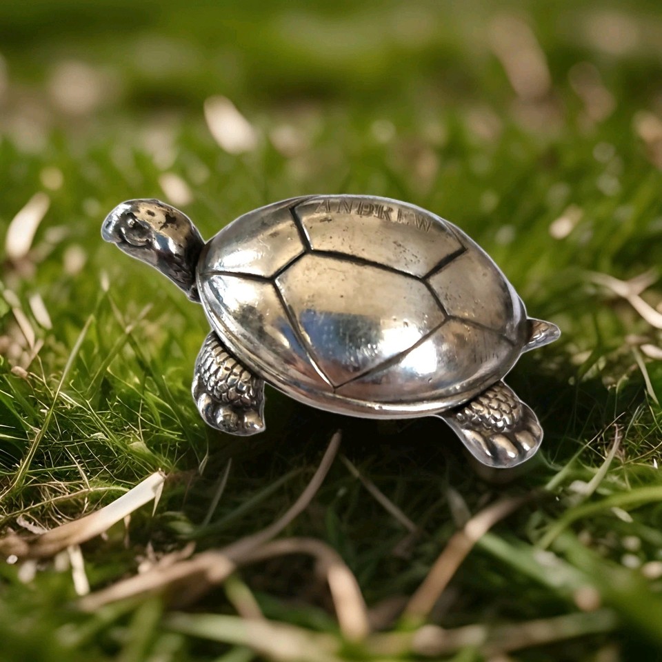 Reed & Barton silverplate turtle music box playing Brahms' Lullaby — a collectible brand name piece with a monogram and working movement.