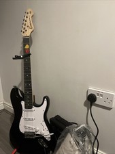 Black stratocaster 2picks capo and more in photos.(Foam inside may be damaged)