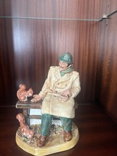 This is a Royal Doulton figurine named "Lunchtime", model number HN 2485.