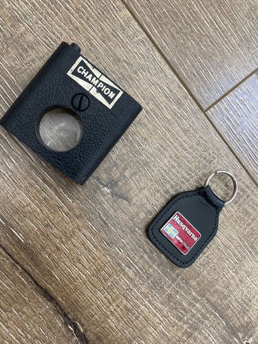 Vintage Husqvarna key fob with Champion spark plug pocket light/magnafi glass