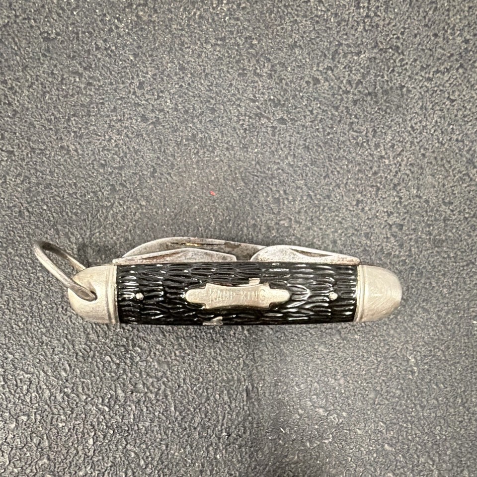 A USA-made vintage Kamp-King multi-tool pocket knife with classic jigged black handle and can opener — the kind of everyday carry your grandpa actually trusted.