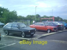 Photo 6x4 Classic Fords in the car park Syston/SK6211 A Mk1 Fiesta and a c2006