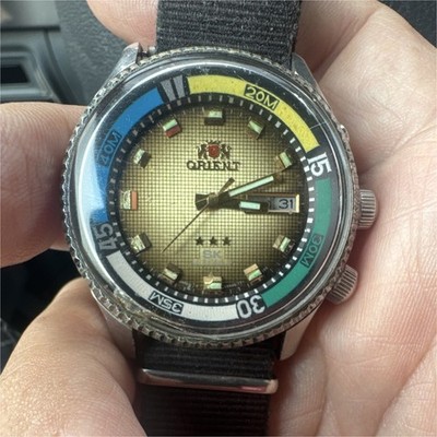 Orient SK Automatic 21 Jewels Day/Date Gold Dial Multicolor Bezel Black Strap