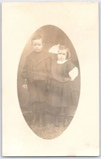 Vintage Sepia RPPC  Postcard of Two Children in Early 20th Century Attire