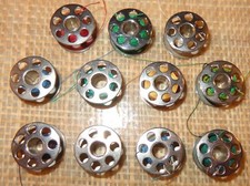 11 OLD VINTAGE METAL SEWING BOBBINS 3/4" WIDE WITH 7 HOLES SIDE SMOOTH SIDE