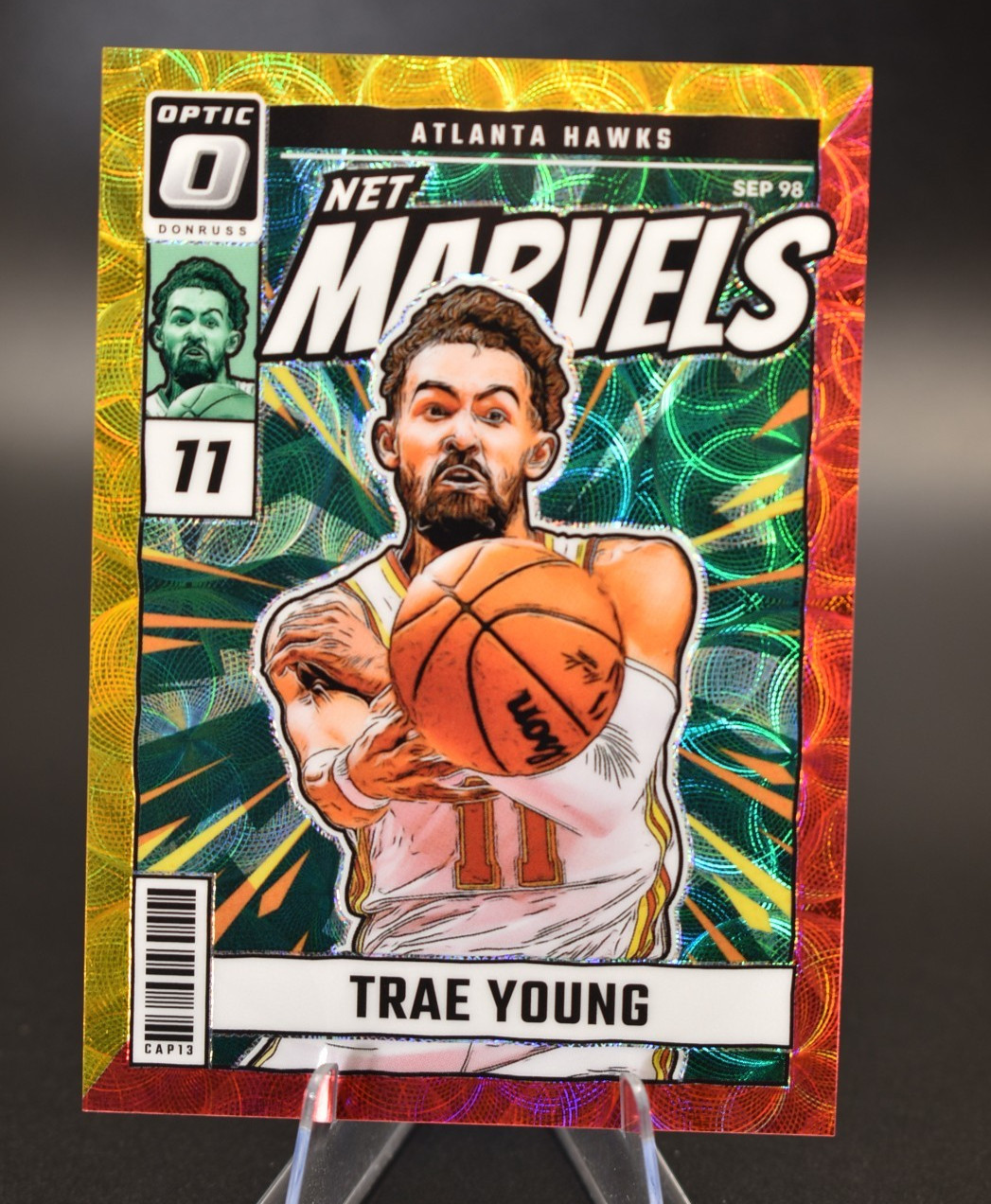 2024-25  Optic - Net Marvels Trae Young #9 International Red & Gold Prizm /99