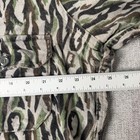 Vintage woolrich men’s XL shirt with green and brown camouflage pattern, button front, and white measuring tape.