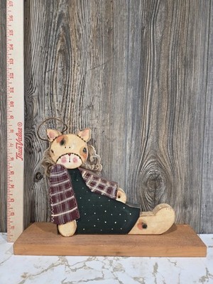 handcrafted wooden cat,  rustic, folk-art style painted details, fabric clothing