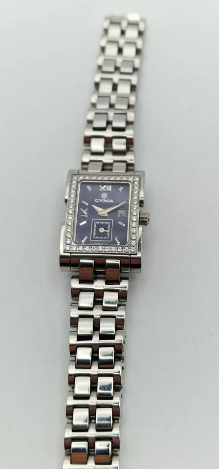 Reloj Cyma Tank para dama con bisel de diamantes y esfera azul en caja con papeles. Foto 4 de 4