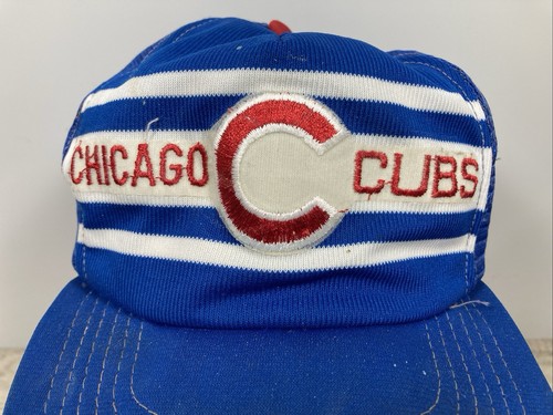 Blue snapback trucker hat with white and red stripe bands and embroidered “Chicago Cubs” text in red lettering.