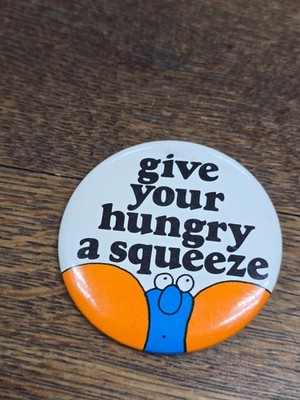   GIVE YOUR HUNGRY A SQUEEZE Orange Blue Button Badge Antique
