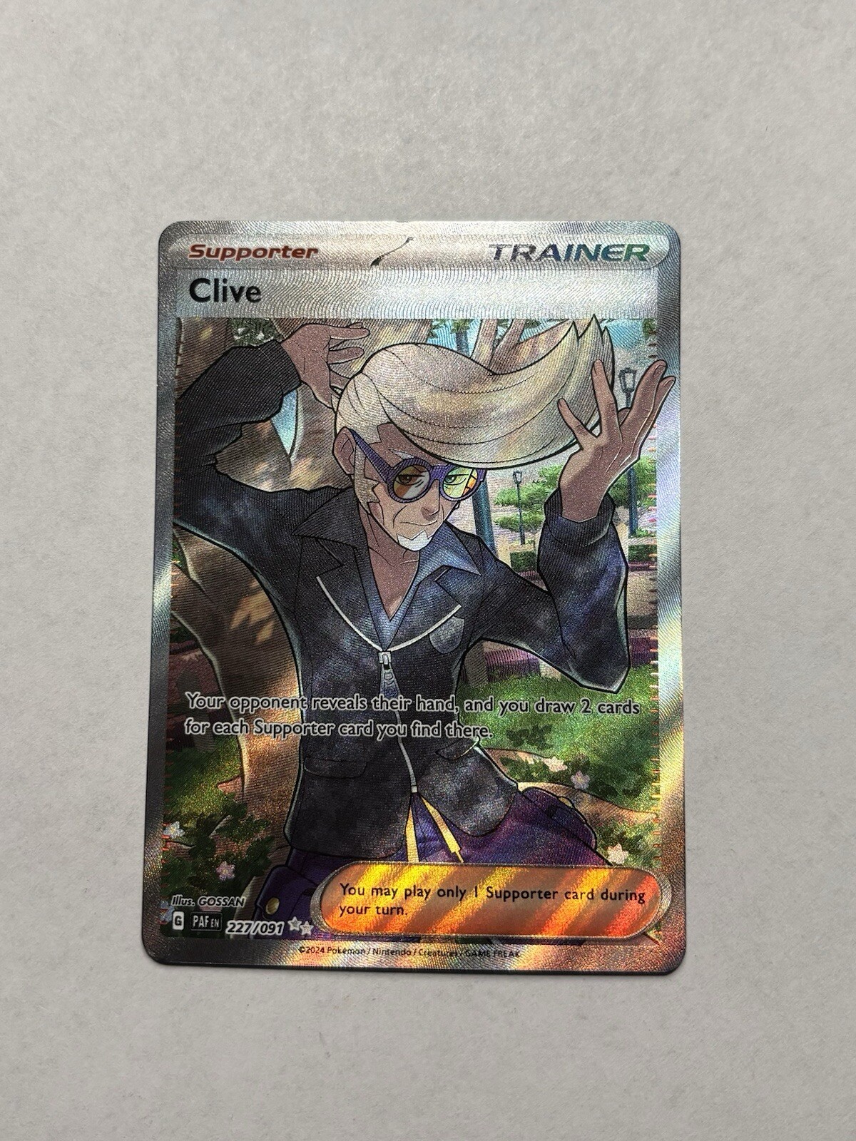 Clive 227/091 Ultra Rare Full Art Trainer Paldean Fates Pokemon NM/M