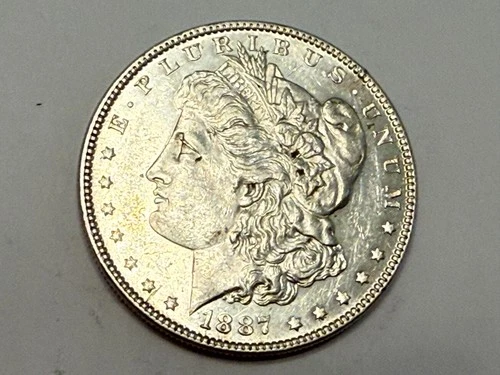 1887 Morgan U.S. silver dollar. Semi-prooflike choice AU-UNC slider. #ek1