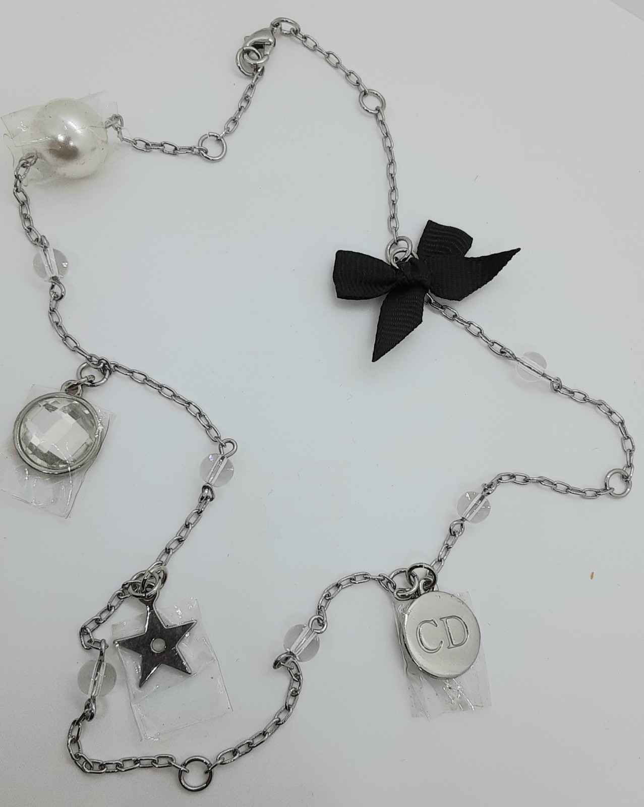 Dior 20-Inch Silver Charm Necklace with Bow Star Pearl Prism
