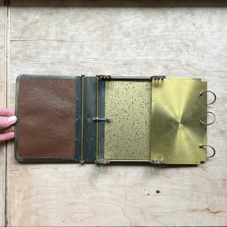 A 1920s–30s Art Deco executive memo pad with a built-in privacy cover — the kind of object that makes a home office feel like a detective's headquarters.