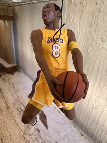 2003 Hallmark Hoop Stars ornament of Kobe Bryant in yellow Lakers jersey holding basketball, with purple and gold accents.