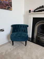 Beautiful upholstered accent chair in a rich teal/blue velvet fabric