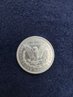 1921 morgan silver dollar coin with a handmade leather pouch.
