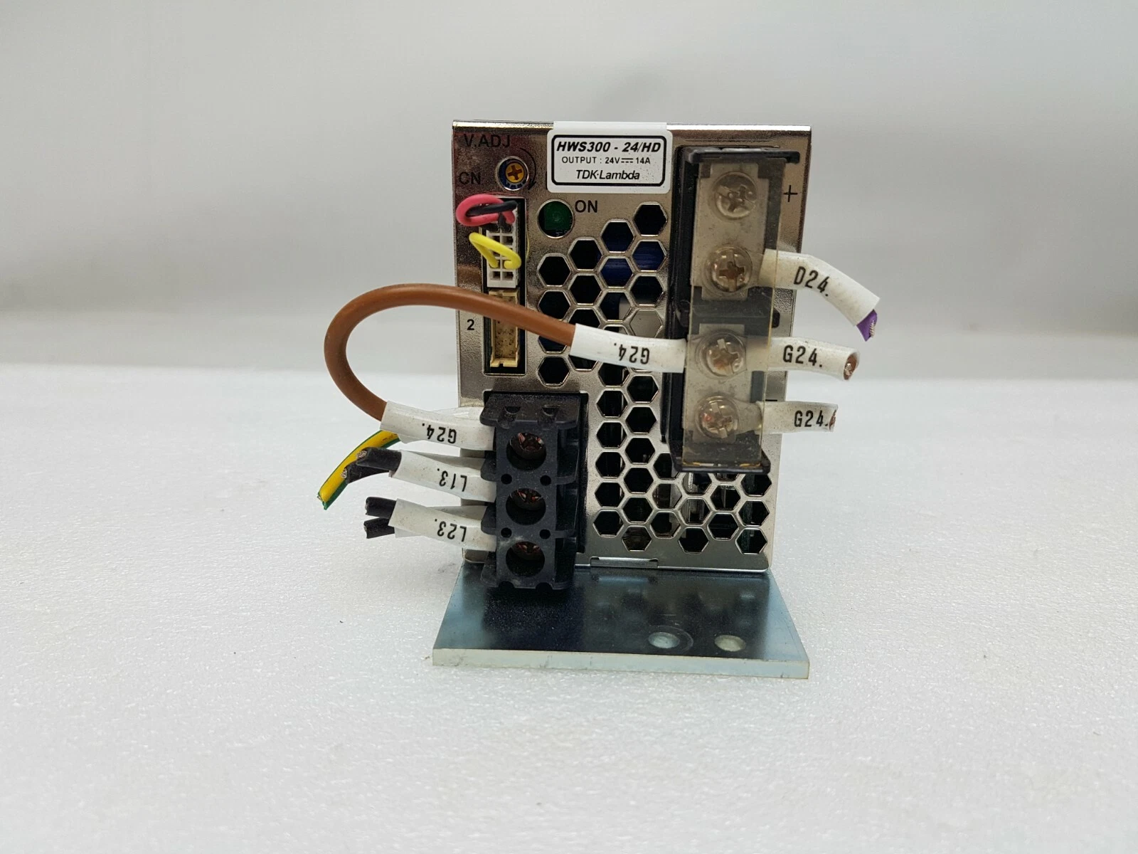 Front end of the HWS300-24/HD with terminal block, V.ADJ trimmer and labelled wires