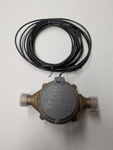 Used Badger model 25 5/8" brass water meter with HR E lcd register