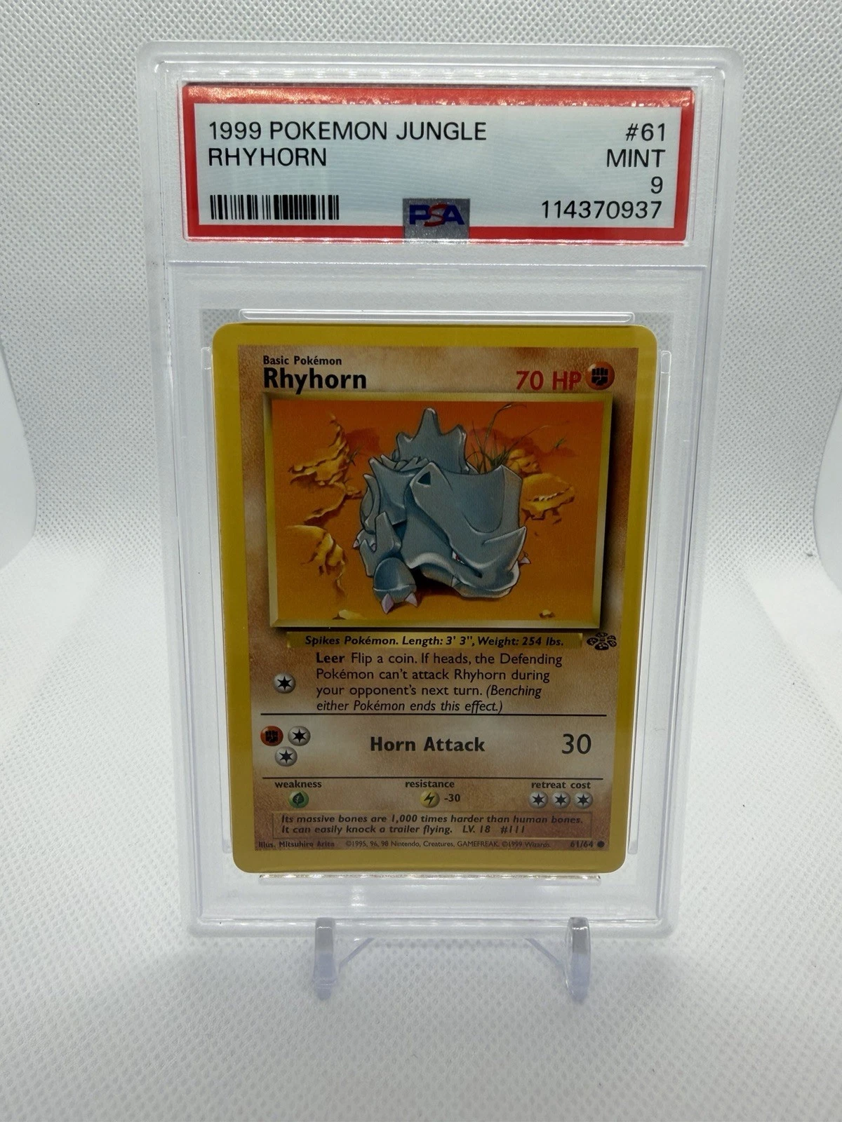 A graded Pokemon card in its holder