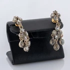 585 gold and silver earrings with 0.40ct diamond roses