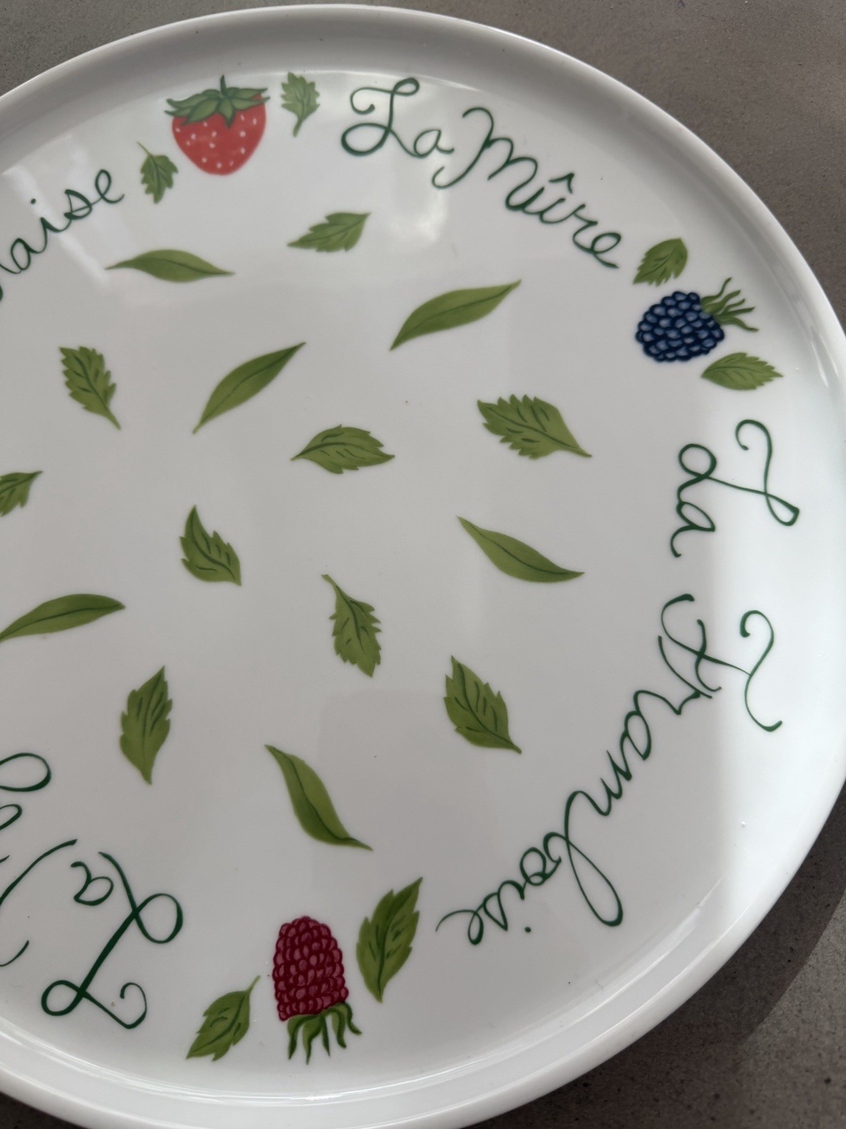 Philippe Deshoulieres Apilco porcelain plate with a fruit design. 11 7/8"