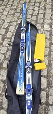 Fischer Revolution skis include Salomon bindings and a black carrying bag