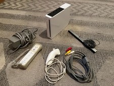 Nintendo Wii console with nunchuck controller cables and motion sensor used