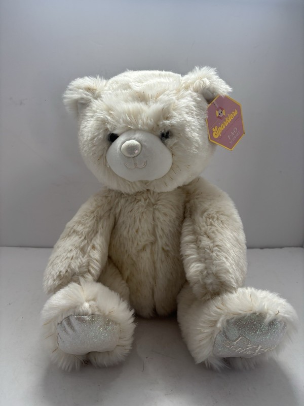 a FAO Schwarz Sparklers bear plush in cream white with glitter accents.