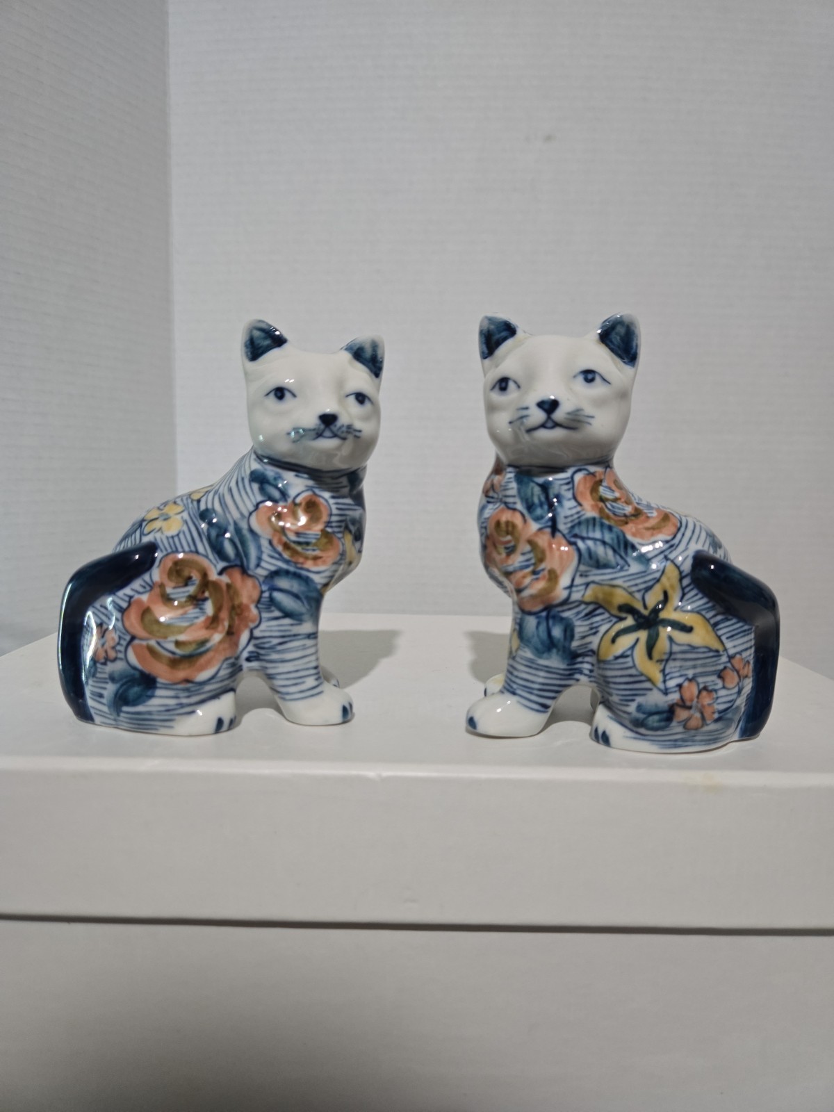 Pair of Ceramic Cat Figurines, Blue and White with a Floral Motif