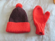 Handknitted child's stocking cap and mittens.
